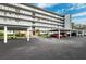 Exterior view of the condo building featuring covered resident parking and meticulous landscaping at 4240 Ironwood Cir # 404, Bradenton, FL 34209