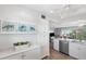 Contemporary white kitchen design with sleek countertops, stainless steel dishwasher, and ample storage at 4240 Ironwood Cir # 404, Bradenton, FL 34209