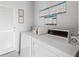 On-site laundry room with multiple washing machines and posted laundry guidelines at 4240 Ironwood Cir # 404, Bradenton, FL 34209