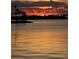 Stunning waterfront view at sunset, featuring silhouetted trees and vibrant colors reflecting on the water at 4851 W Gandy Blvd # B13L27, Tampa, FL 33611