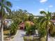 Aerial view of the charming single-story home with tropical landscaping at 611 Casabella Dr, Bradenton, FL 34209