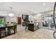 Well-appointed kitchen and dining area featuring stainless steel appliances, island seating, and patio access at 611 Casabella Dr, Bradenton, FL 34209