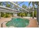 Private screened-in pool surrounded by a spacious deck and tropical foliage at 611 Casabella Dr, Bradenton, FL 34209