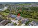 Stunning aerial view of a home with a well-manicured lawn and landscaping surrounded by lush trees at 618 Manns Harbor Dr, Apollo Beach, FL 33572