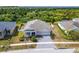Beautiful aerial view of single-story home with lush landscaping and gray brick driveway at 618 Manns Harbor Dr, Apollo Beach, FL 33572
