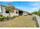 Beautiful backyard with lush landscaping, mature trees, and a classic white picket fence at 618 Manns Harbor Dr, Apollo Beach, FL 33572
