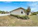 Beautiful backyard with lush landscaping, mature trees, and a classic white picket fence at 618 Manns Harbor Dr, Apollo Beach, FL 33572