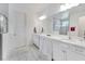 Large, luxurious bathroom with white marble floors and countertops at 618 Manns Harbor Dr, Apollo Beach, FL 33572