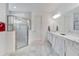 Bright bathroom featuring a shower and a marble countertop at 618 Manns Harbor Dr, Apollo Beach, FL 33572