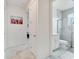 Well-lit bathroom with tiled floors, glass shower, and white fixtures at 618 Manns Harbor Dr, Apollo Beach, FL 33572