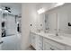 Elegant bathroom featuring double sinks, modern fixtures, and a door leading to another room, showcasing its style at 618 Manns Harbor Dr, Apollo Beach, FL 33572