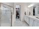 Bathroom featuring a glass enclosed shower, toilet, vanity with mirror and walk-in closet at 618 Manns Harbor Dr, Apollo Beach, FL 33572