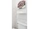 Bathroom featuring a toilet and metal shelving with decor and toiletries at 618 Manns Harbor Dr, Apollo Beach, FL 33572