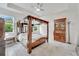 Spacious primary bedroom featuring a four-poster bed, tile floors, and lots of light at 618 Manns Harbor Dr, Apollo Beach, FL 33572