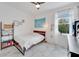 Bright bedroom featuring stylish furniture, natural light, and light-colored floors; creating a comfortable space at 618 Manns Harbor Dr, Apollo Beach, FL 33572
