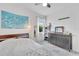 Comfortable bedroom with a turtle tapestry, bright lighting, and light-colored wood look floors, offering a peaceful retreat at 618 Manns Harbor Dr, Apollo Beach, FL 33572