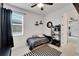 Comfortable bedroom with a ceiling fan, window with blinds, and an open doorway at 618 Manns Harbor Dr, Apollo Beach, FL 33572
