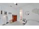 Inviting bedroom with wood dresser, light-colored floors, and ample natural light from the window at 618 Manns Harbor Dr, Apollo Beach, FL 33572