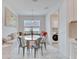 Breakfast nook with bench seating and a glass top table next to the laundry room at 618 Manns Harbor Dr, Apollo Beach, FL 33572