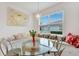 Sunlit breakfast nook featuring banquette seating beneath a large window and elegant lighting at 618 Manns Harbor Dr, Apollo Beach, FL 33572