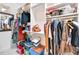Walk-in closet with shelving full of clothes, purses, storage boxes and accessories at 618 Manns Harbor Dr, Apollo Beach, FL 33572
