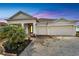 Inviting home with an extended driveway, three-car garage, and elegant exterior lighting at 618 Manns Harbor Dr, Apollo Beach, FL 33572