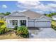 Charming home with a manicured lawn, palm trees, and a spacious three-car garage at 618 Manns Harbor Dr, Apollo Beach, FL 33572