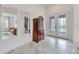 Foyer with decorative doors, dark wood chest of drawers and two mirrors at 618 Manns Harbor Dr, Apollo Beach, FL 33572