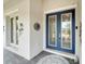 Elegant front entrance with a double door, covered porch, and decorative accents at 618 Manns Harbor Dr, Apollo Beach, FL 33572