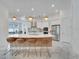 Modern kitchen with an island, breakfast bar, and stainless-steel appliances at 618 Manns Harbor Dr, Apollo Beach, FL 33572