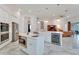 Bright kitchen featuring stainless appliances, double islands, and a wine fridge, flowing into the living space at 618 Manns Harbor Dr, Apollo Beach, FL 33572