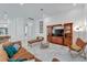 Comfortable living room with a large cabinet, leather sofa, and neutral color palette at 618 Manns Harbor Dr, Apollo Beach, FL 33572