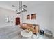 Living room with a tan leather couch, light colored rug, and modern light fixture at 618 Manns Harbor Dr, Apollo Beach, FL 33572