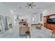 Open-concept living room with marble floors, a leather sofa, and elegant decor at 618 Manns Harbor Dr, Apollo Beach, FL 33572