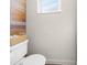 Cozy bathroom features natural wood accents and a new toilet fixture at 6840 Mesa Verde St, Port Richey, FL 34668