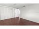 Bedroom featuring a closet with louvered doors and hardwood-style flooring at 6840 Mesa Verde St, Port Richey, FL 34668