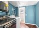 Laundry room with modern washer and dryer, blue walls, and tile accents at 6840 Mesa Verde St, Port Richey, FL 34668