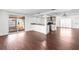 Spacious, open-concept living area with wood flooring, updated fixtures, and abundant natural light at 6840 Mesa Verde St, Port Richey, FL 34668