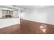 Open living space with sleek hardwood floors and kitchen bar, perfect for entertaining at 6840 Mesa Verde St, Port Richey, FL 34668
