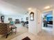 Spacious living room leading to the kitchen area, featuring tile flooring and neutral decor at 6880 Greenbrier Dr, Seminole, FL 33777