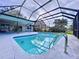 A beautiful screened-in pool has a ladder and plenty of room for relaxing in the sun or shade at 6880 Greenbrier Dr, Seminole, FL 33777