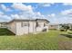 Exterior view of the home highlighting the backyard with green grass at 7133 El Matador St, Zephyrhills, FL 33541