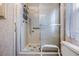 Bathroom with a shower stall featuring a sliding door, safety bars, and fish accents at 7133 El Matador St, Zephyrhills, FL 33541