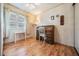 Bedroom with a wood floor, large window, writing desk, and antique wooden desk with drawers at 7133 El Matador St, Zephyrhills, FL 33541