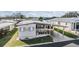 Single Gathering home featuring an attached carport, landscaped yard, and outdoor seating area at 7133 El Matador St, Zephyrhills, FL 33541