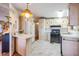 Well-lit kitchen featuring white appliances, marble countertops, and modern flooring at 7133 El Matador St, Zephyrhills, FL 33541