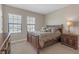 Comfortable bedroom featuring a full-sized bed, a nightstand, and natural light from the windows at 8414 Eagle Brook Dr, Land O Lakes, FL 34638