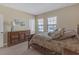 Comfortable bedroom with wood dresser, neutral walls, and bright windows at 8414 Eagle Brook Dr, Land O Lakes, FL 34638