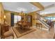 Elegant dining room boasts a chandelier, decorative rug, and adjacent staircase, perfect for entertaining guests at 8414 Eagle Brook Dr, Land O Lakes, FL 34638