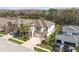 Beautiful two-story home with a three-car garage, lush landscaping, and backyard pond view at 8414 Eagle Brook Dr, Land O Lakes, FL 34638